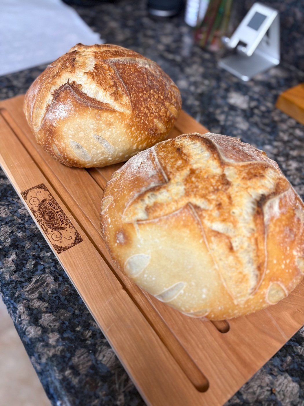 Two sourdough loaves on a cutting board